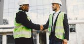 multi-racial-builders-handshaking-outdoors-wearing-uniform-talking-about-new-glass-building-working-poject-city-infrastructure_1157-50877